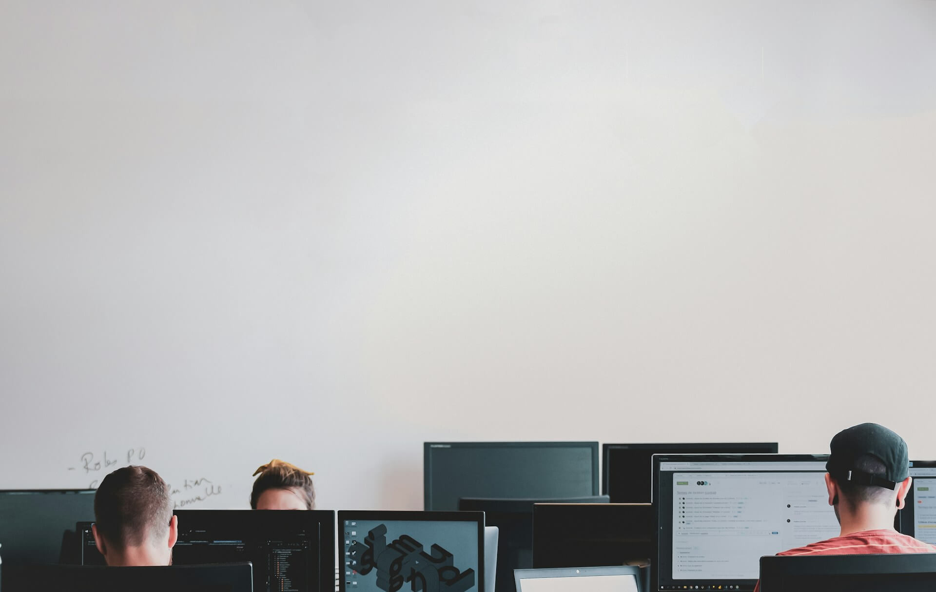 image of people working at their desk in an open office space